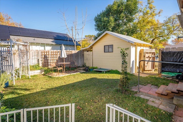 view of yard with a fenced backyard, an outbuilding, and a storage unit