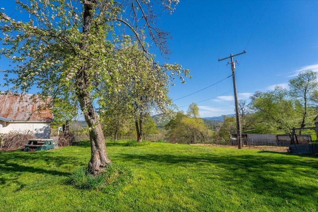 view of yard with a mountain view and fence