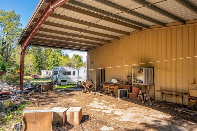 view of patio / terrace featuring a carport and an outbuilding