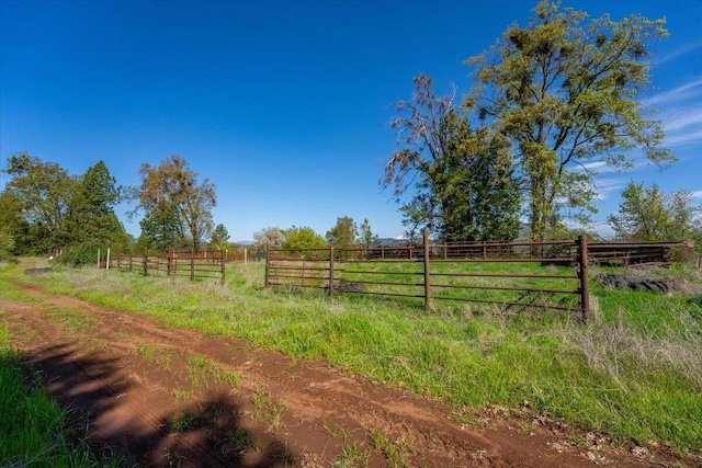 view of yard with a rural view and fence