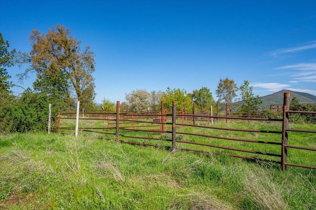 view of yard featuring a rural view and fence