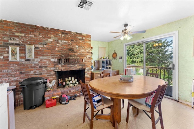 dining area featuring a fireplace, visible vents, and a ceiling fan