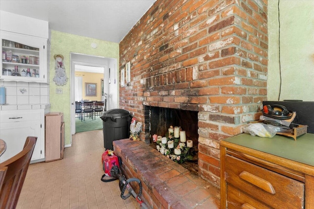 living room with a brick fireplace