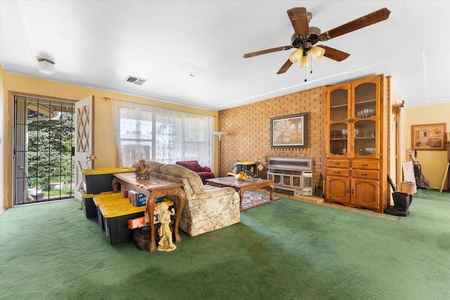 living room featuring carpet flooring, a ceiling fan, visible vents, and a wealth of natural light
