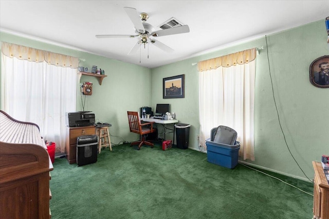 carpeted home office with visible vents, a wealth of natural light, and ceiling fan
