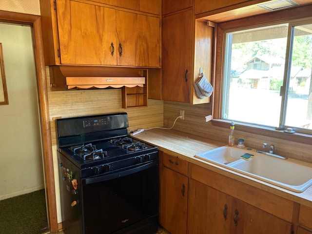 37061 Park Ave, Burney, CA 96013 - kitchen with black gas stove, a sink, light countertops, and plenty of natural light