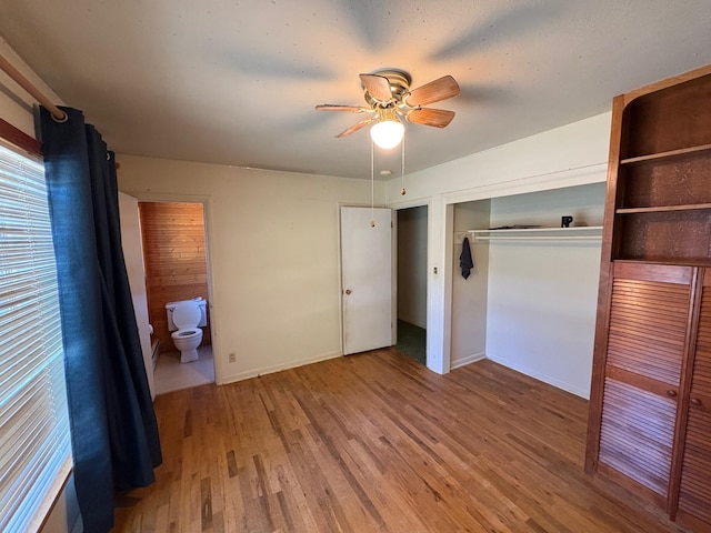 37061 Park Ave, Burney, CA 96013 - unfurnished bedroom featuring wood finished floors, baseboards, a closet, and a ceiling fan