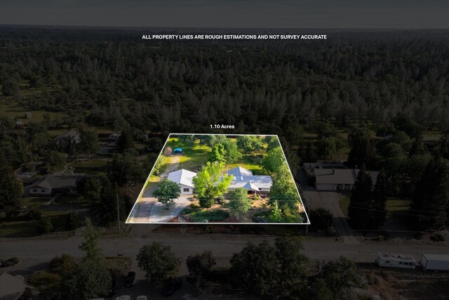 birds eye view of property with a forest view