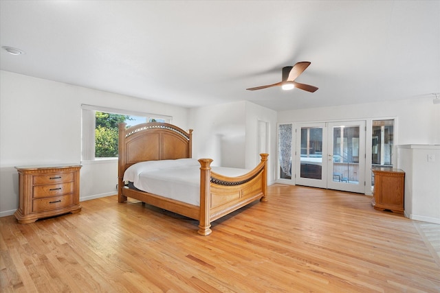 bedroom featuring baseboards, french doors, access to exterior, and light wood-style flooring