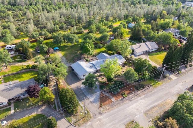birds eye view of property featuring a view of trees and a residential view