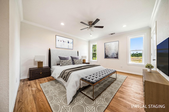 bedroom with ornamental molding, visible vents, and light wood-style floors
