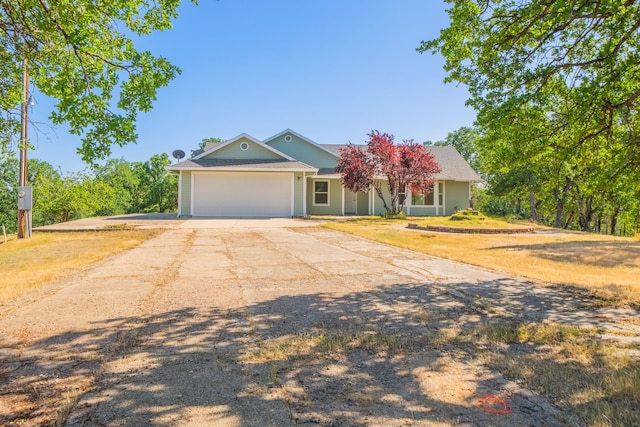 view of front of house with concrete driveway and an attached garage