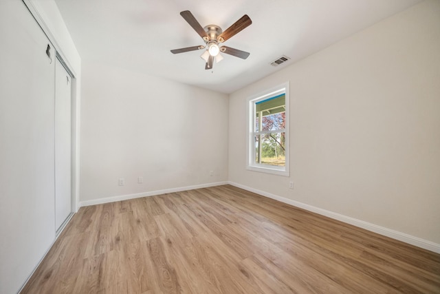 unfurnished bedroom with baseboards, visible vents, and light wood-style floors