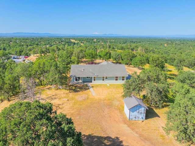 birds eye view of property with a forest view