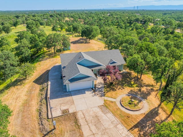 drone / aerial view featuring a forest view