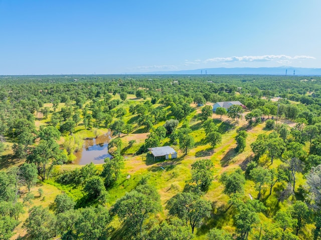 aerial view with a wooded view and a water view