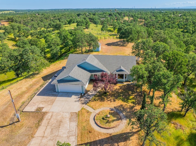 bird's eye view with a wooded view