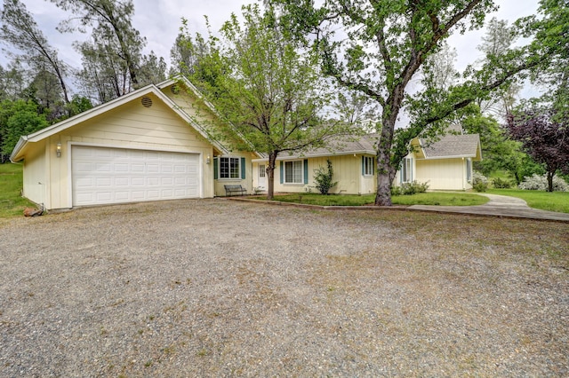 9400 Placer Rd, Redding, CA 96001 - view of front of home featuring an attached garage and gravel driveway