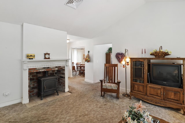 9400 Placer Rd, Redding, CA 96001 - carpeted living area featuring visible vents, a wood stove, high vaulted ceiling, and baseboards