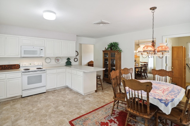 9400 Placer Rd, Redding, CA 96001 - kitchen featuring an inviting chandelier, white appliances, a peninsula, white cabinets, and visible vents