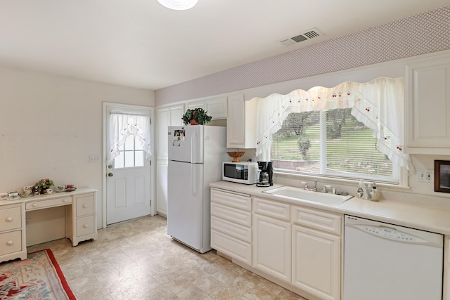 9400 Placer Rd, Redding, CA 96001 - kitchen featuring white appliances, visible vents, a sink, and a healthy amount of sunlight