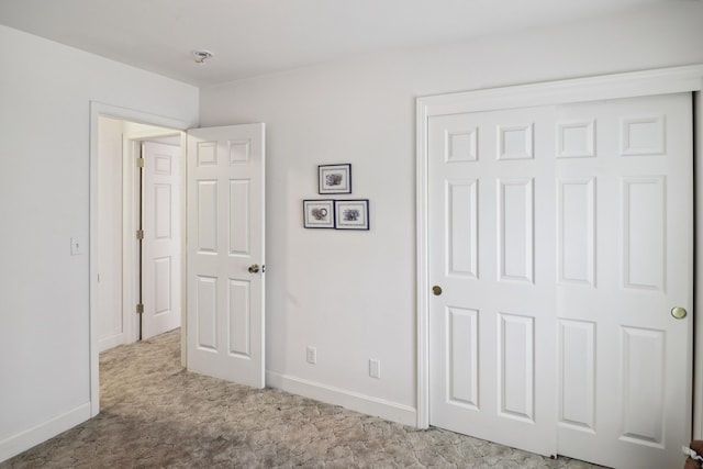 9400 Placer Rd, Redding, CA 96001 - unfurnished bedroom featuring a closet, baseboards, and carpet