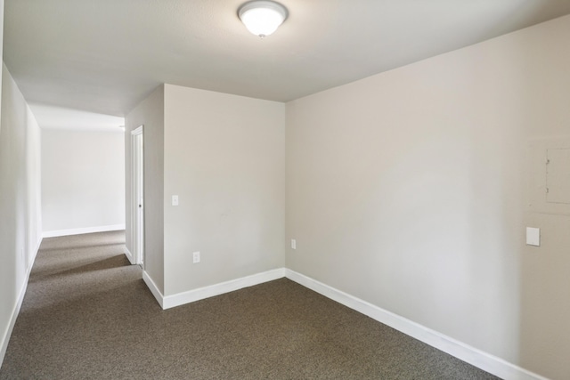 9400 Placer Rd, Redding, CA 96001 - empty room featuring dark colored carpet and baseboards