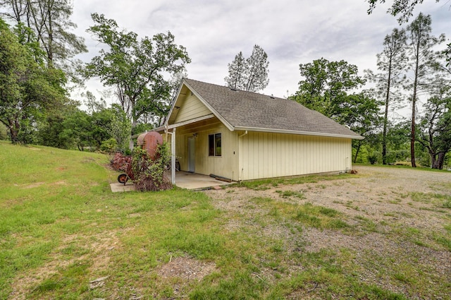 9400 Placer Rd, Redding, CA 96001 - view of property exterior with a yard, a patio, and roof with shingles