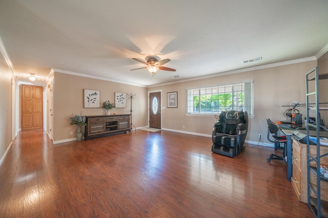 office space featuring baseboards, ornamental molding, ceiling fan, visible vents, and wood finished floors