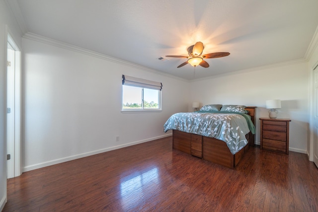 bedroom with baseboards, crown molding, visible vents, and wood finished floors