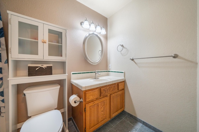 full bathroom with toilet and vanity