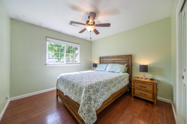 bedroom with ceiling fan, baseboards, visible vents, and wood finished floors