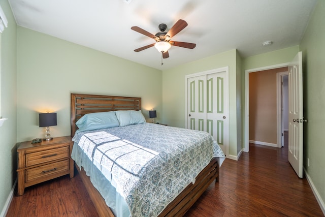 bedroom with a closet, baseboards, a ceiling fan, and dark wood-style floors