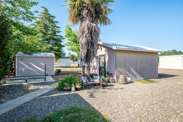 exterior space with an outdoor structure and a storage shed