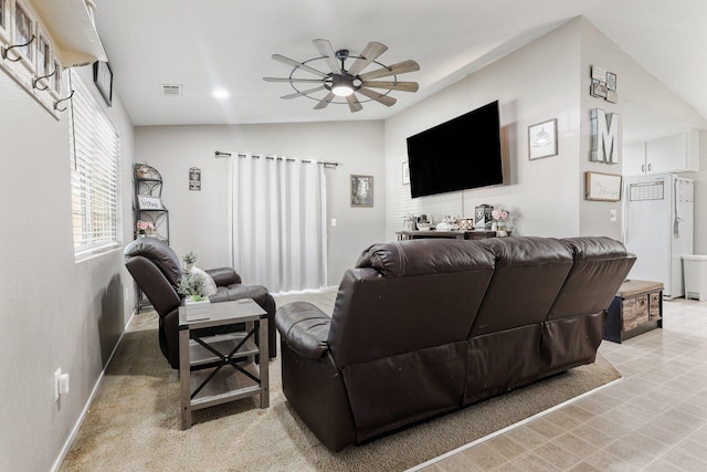 living area with ceiling fan, baseboards, and visible vents