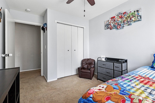 bedroom with carpet floors, baseboards, a closet, and ceiling fan