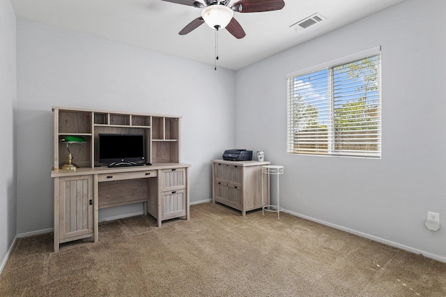 home office featuring baseboards, light colored carpet, ceiling fan, and visible vents