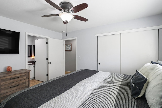 bedroom with a closet, ceiling fan, and ensuite bath