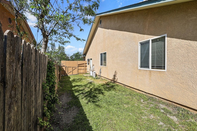 view of home's exterior featuring a yard, a fenced backyard, and stucco siding