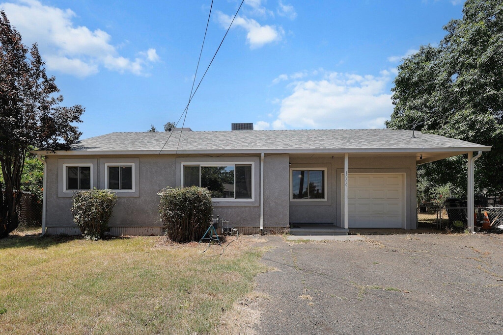 1000 A St, Redding, CA 96002 - ranch-style house featuring a garage, asphalt driveway, stucco siding, and a shingled roof