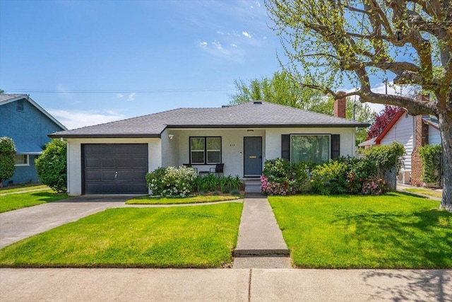 view of front of property featuring a front yard, driveway, a garage, and stucco siding