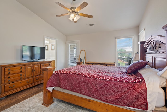 bedroom featuring lofted ceiling, visible vents, ceiling fan, wood finished floors, and ensuite bath