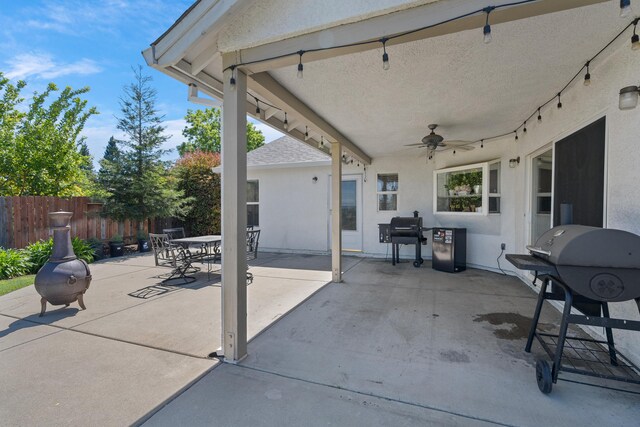 view of patio featuring outdoor dining space, ceiling fan, a grill, and fence
