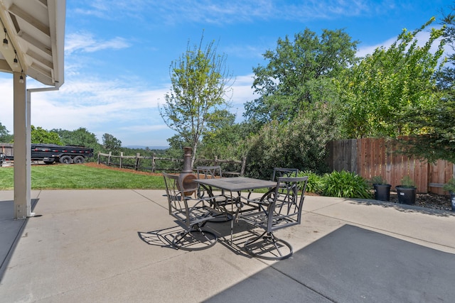 view of patio with fence and outdoor dining area