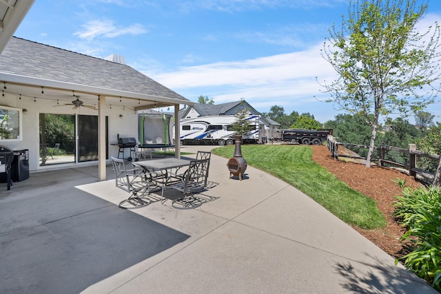 view of patio / terrace with fence, outdoor dining area, and a ceiling fan