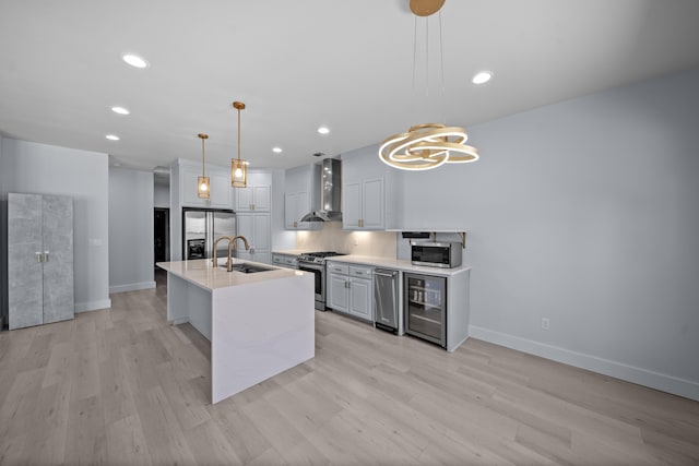 2120 Tradition Way, Redding, CA 96001 - kitchen with wall chimney exhaust hood, appliances with stainless steel finishes, light wood-style floors, pendant lighting, and recessed lighting