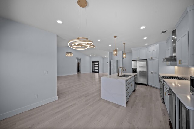 2120 Tradition Way, Redding, CA 96001 - kitchen featuring appliances with stainless steel finishes, wall chimney range hood, light countertops, recessed lighting, and hanging light fixtures