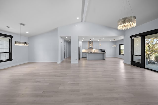2120 Tradition Way, Redding, CA 96001 - unfurnished living room with a chandelier, beamed ceiling, light wood-style floors, recessed lighting, and high vaulted ceiling