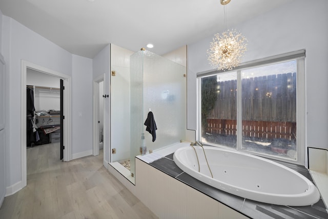 2120 Tradition Way, Redding, CA 96001 - bathroom with a shower stall, wood finished floors, a tub with jets, a chandelier, and a spacious closet