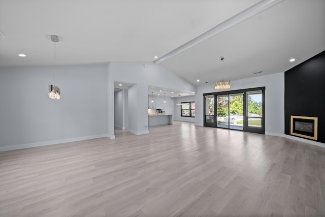 2120 Tradition Way, Redding, CA 96001 - unfurnished living room featuring a chandelier, light wood-type flooring, a fireplace, recessed lighting, and beam ceiling